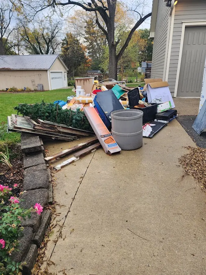 Dumpster being loaded with debris for Commercial Dumpster Rental in Kings Park West